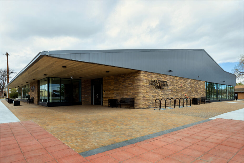 Completed Park County Library exterior with stone veneer, curtain wall glazing, and wood soffit