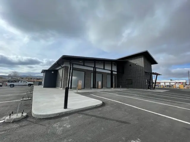 Front entrance of Rocky Mountain Car Wash in Rock Springs, Wyoming featuring modern commercial architecture, covered customer entrance, and completed site construction.