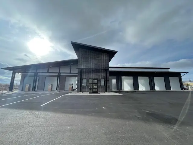 Exterior view of Rocky Mountain Car Wash in Rock Springs, Wyoming featuring a modern commercial building with multiple wash bays, contemporary architecture, and durable construction completed for long term performance.