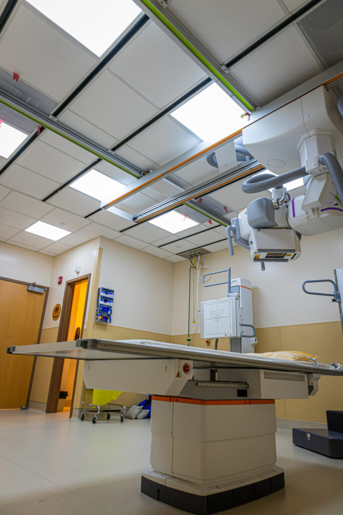 Advanced medical imaging room with digital X-ray system and ceiling mounted equipment.