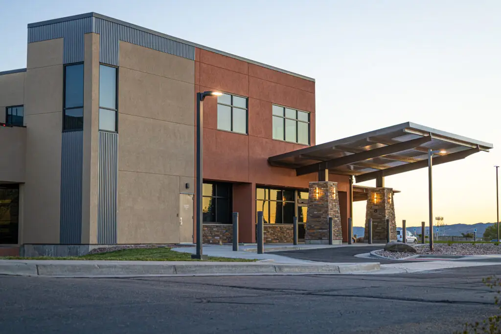 Modern healthcare facility exterior with covered entrance and contemporary commercial architecture.