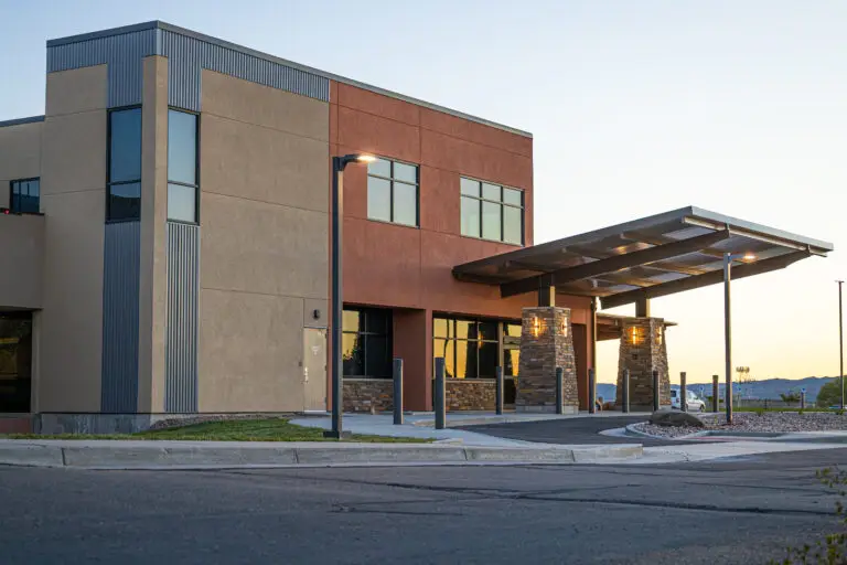 Modern healthcare facility exterior with covered entrance and contemporary commercial architecture.