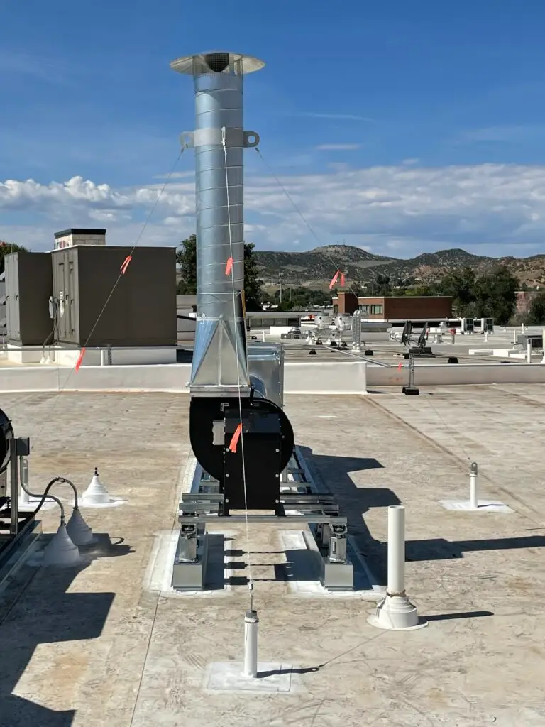Dedicated rooftop exhaust fan supporting negative pressure isolation rooms at Hot Springs County Hospital with new mechanical systems designed to meet healthcare ventilation requirements.